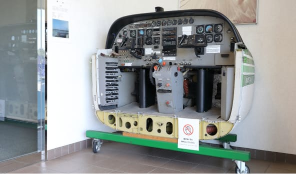 A cut model of the cockpit equipped in the damaged aircraft (JA8897) is displayed in the lobby of the head office in Chofu, Tokyo in order to tell for posterity that the 2011 East Japan Great Earthquake and Tsunami caused tremendous damage to us.